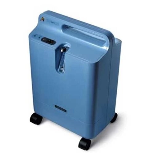 Philips Respironics EverFlo 5 LPM oxygen concentrator — angled view of the light blue unit with recessed carry handle and castor wheels