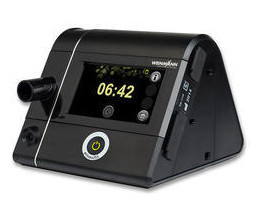 Löwenstein prisma SMART auto CPAP machine — angled view with colour display showing therapy hours